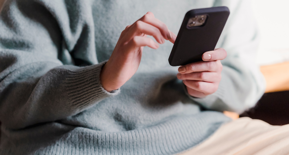woman's hand using cell phone