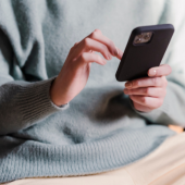 woman's hand using cell phone
