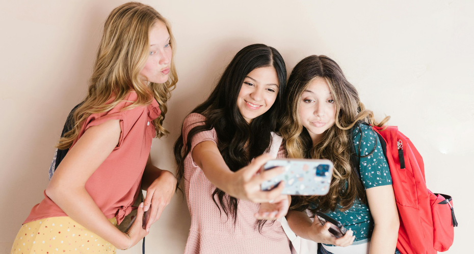 teen girls taking selfie
