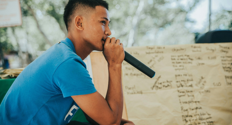 Young man speaking into mic
