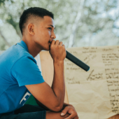 Young man speaking into mic